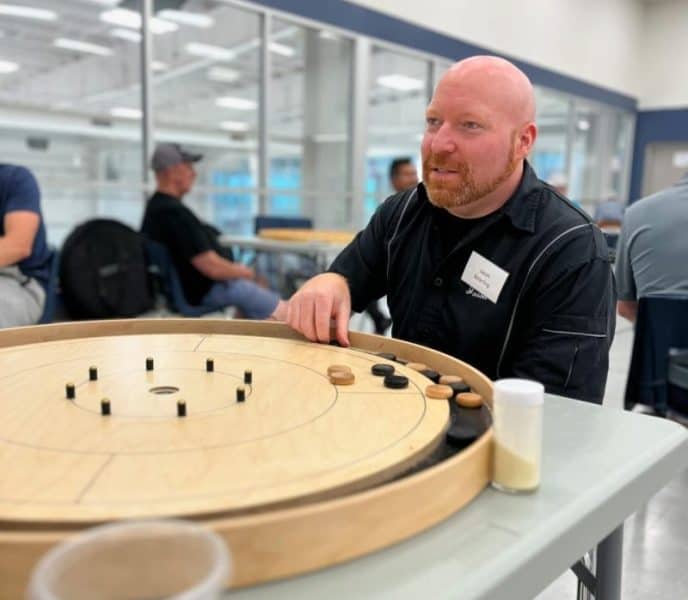 Jason Beierling at a Crokinole Board